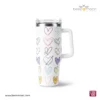 Professional product shot of a Beezmoon white insulated tumbler with multi-colored hand-drawn heart doodles, featuring a white ergonomic handle and clear lid (Code 130).