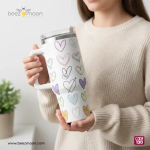 A female model holding the large-capacity 1300ml Beezmoon "Doodle Hearts" tumbler, showcasing its "Big size and heavy" duty build and premium finish.