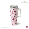 Professional product photography of a Beezmoon white insulated tumbler with a red heart and "LOVE" pattern, featuring a sturdy white handle and clear lid (Code 128).